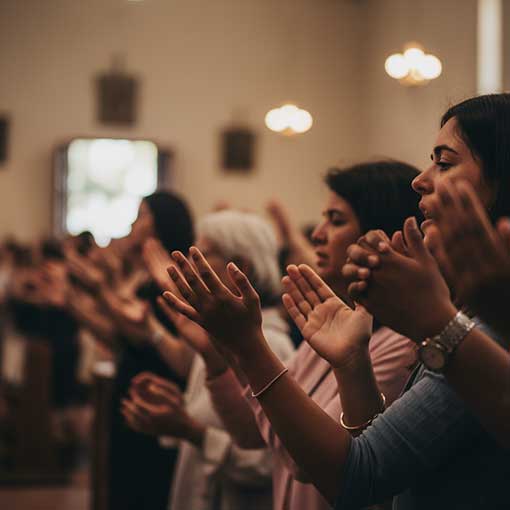 Close-up of diverse hands in genuine worship, symbolizing the commitment to Biblically driven worship.