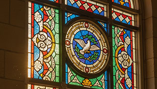 A restored stained glass window in a church, symbolizing revitalization and renewal.